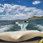 Boat renters on tube on back of boat at Horsetooth Reservoir